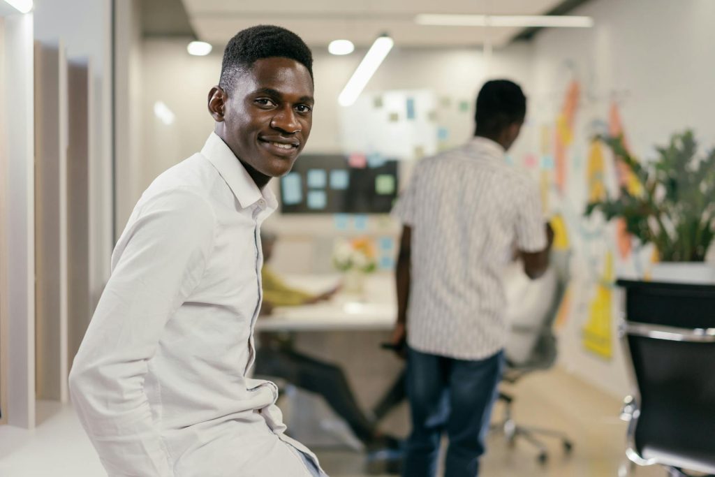 Man in White Long Sleeves Polo Smiling at the Camera